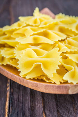 Raw pasta on wooden backgroundの写真素材
