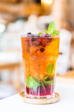 Fruits juice cocktail mixed with mint, lime, blueberry and berryの写真素材