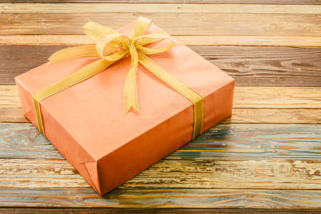 Gift box on wooden background - vintage effectの写真素材