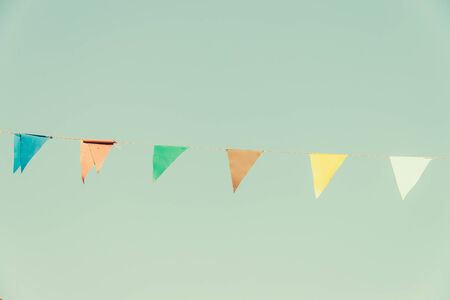 Colorful flag on blue sky - vintage effect style picturesの写真素材