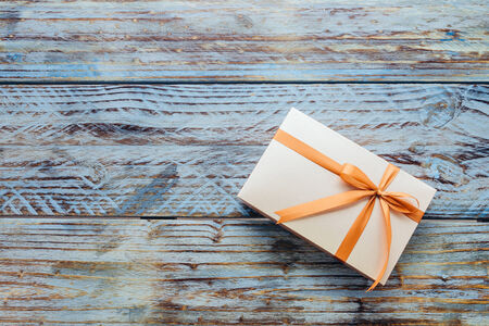 Gift box on wooden background - vintage effectの写真素材