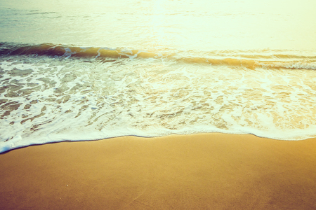 Wave sea water on the beach - vintage effect style and sun flare filter processing style picturesの写真素材