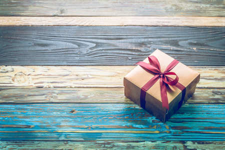 Gift box on wood background - vintage effect style picturesの写真素材