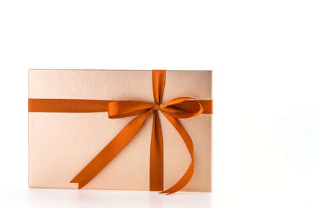 Christmas gold gift box isolated on white backgroundの写真素材