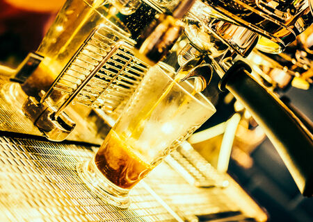 Seletive Coffee cup with coffee machine background - Vintage effect style picturesの写真素材