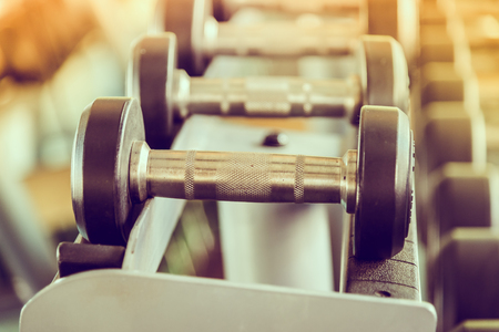 dumbbell in gym - vintage effect and sun flare filter effectの写真素材