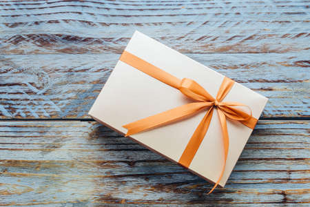 Gift box on wooden background - vintage effectの写真素材