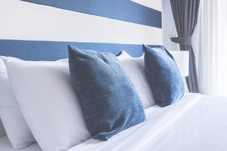 Bed pillow in luxury hotel - vintage film tone effect style processingの写真素材