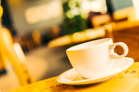 Coffee cup on wooden table in coffee shop - Vintage effect style picturesの写真素材
