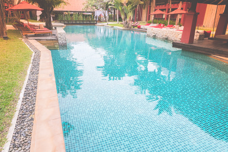 Hotel swimming pool resort - vintage film tone effect and light leak filter processing styleの写真素材