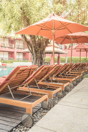 Pool bed in luxury hotel - vintage effect and sun flare filter processingの写真素材