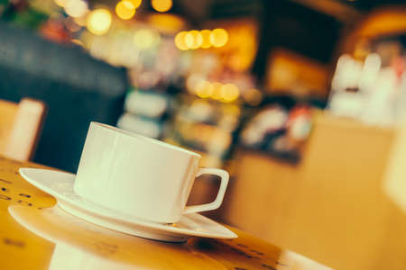 Coffee cup on wooden table in coffee shop cafe - Vintage effect style picturesの写真素材