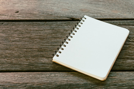 Blank note book paper on wooden backgroundの写真素材