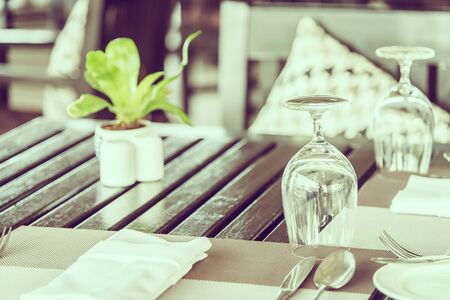 Wine glass on table in restaurant - vintage filter