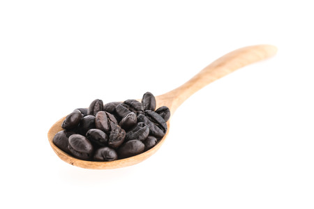 Coffee beans in wooden spoon isolated on white backgroundの写真素材