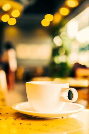 Coffee cup on wooden table in coffee shop - Vintage effect style picturesの写真素材