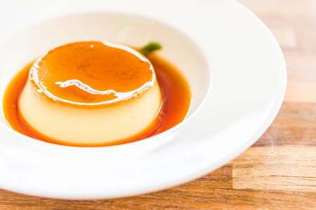 Caramel custard pudding in white plate - selective focus point