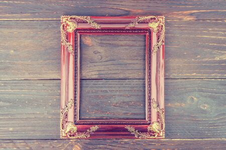 Photo frame on wooden background - vintage style effect pictureの写真素材
