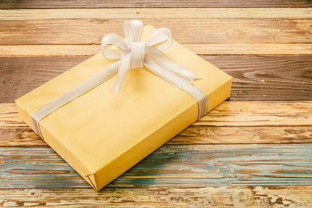 Gift box on wooden background - vintage effectの写真素材