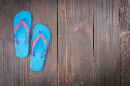 Slipper on wooden background - vintage effect style picturesの写真素材