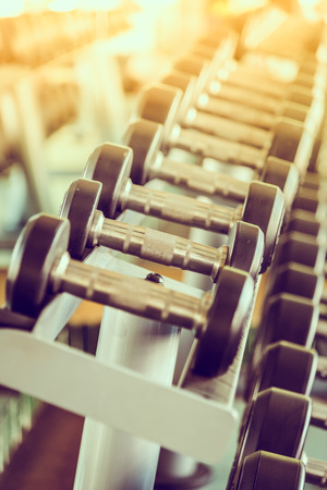 dumbbell in gym - vintage effect and sun flare filter effectの写真素材
