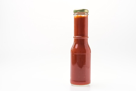 Tomato sauce bottle isolated on white backgroundの写真素材