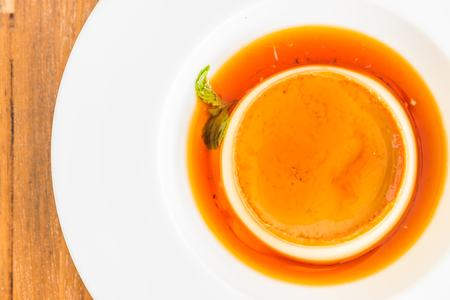 Caramel custard pudding in white plate - selective focus pointの写真素材