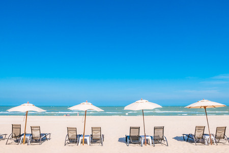 Umbrella bed deck on tropical beach with blue skyの写真素材