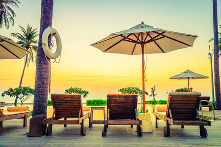 Twilight time Sunset umbrella deck chair pool - vintage filter effectのeditorial素材