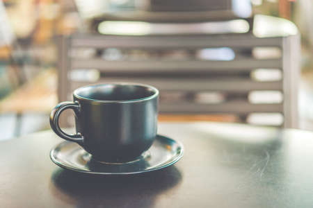 Coffee cup on wooden table in coffee shop - vintage effect style picturesの写真素材