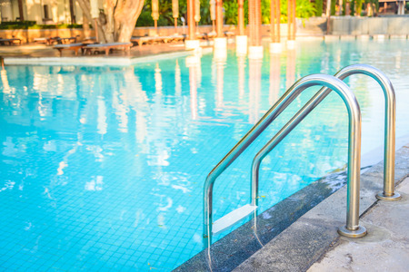 Hotel resort pool on sunrise time - vintage filter and sunflare effect