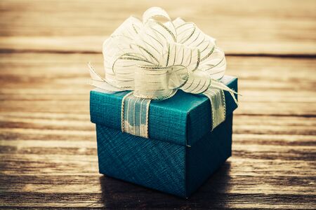 Gift box on wood background - vintage effect style pictures