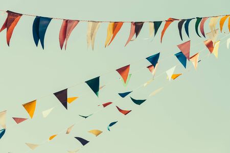 Colorful flag on blue sky - vintage effect style picturesの写真素材