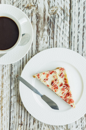 Cranberry cake and coffee cup on wooden background - film effect style picturesの写真素材