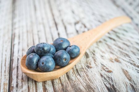 Blueberry spoon on wooden backgroundの写真素材