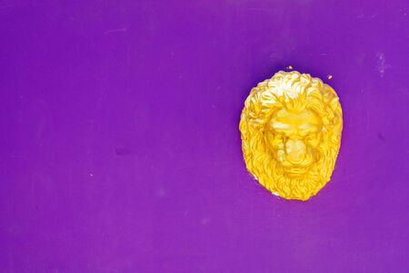 Lion head statue on purple backgroundの写真素材