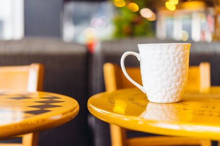 Coffee cup in coffee shop on wooden table - Vintage effect style picturesの写真素材