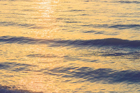 Sun flare on sea water background - vintage filterの写真素材