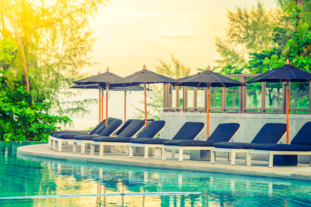 Umbrella pool chair - vintage filter and sunflare effectのeditorial素材