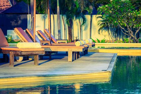 Bed pool deck with sunrise on twilight time - vintage filter effectの写真素材