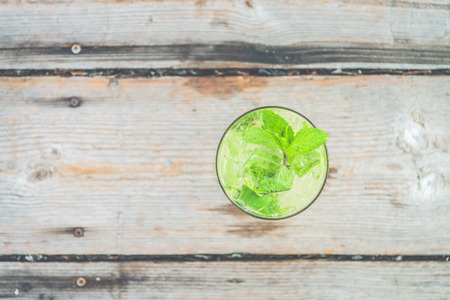 Ice Mojito lime juice cocktail with mint leaf - vintage filter