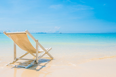 Beach chair on tropical beach sand