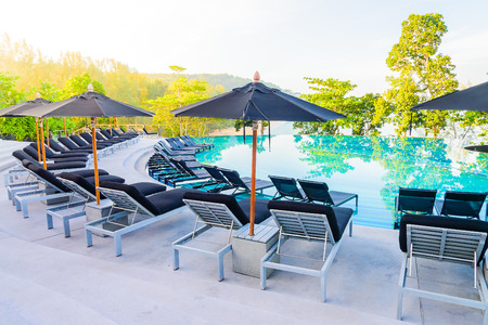 Umbrella pool chair - vintage filter and sunflare effectの写真素材