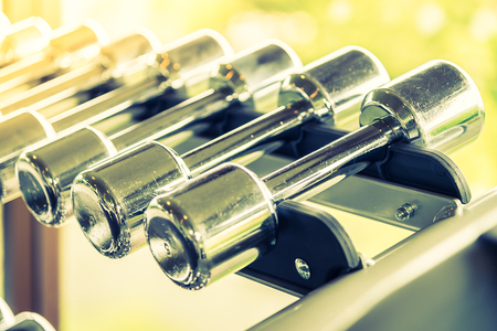 Selective soft focus point on Dumbbells - vintage filter and sunflare effectの写真素材