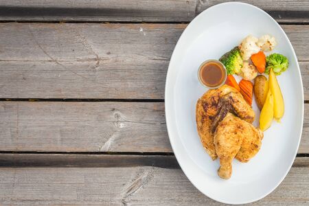 Selective focus point on Grilled chicken meat steak on white plateの写真素材