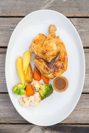 Selective focus point on Grilled chicken meat steak on white plateの写真素材