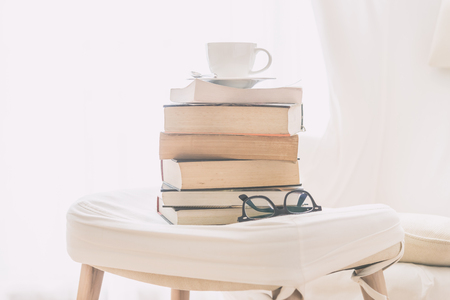 Coffee cup on book and eyeglasses with copy space for text - soft vintage filterの写真素材