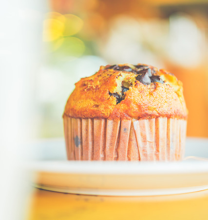 Chocolate muffin in coffee shop - vintage style effect picturesの写真素材