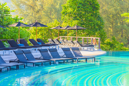 Umbrella pool chair on roof topの写真素材