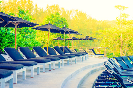 Umbrella pool chair - vintage filter and sunflare effectの写真素材